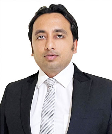 Full portrait of Mr. Digant Sharma, entrepreneur and social architect, in a dark suit and tie against a light background.